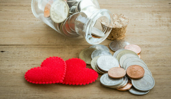 Red,Heart,And,Coin,On,The,Wooden,Table
